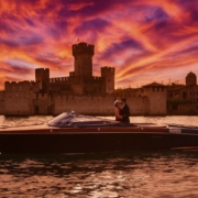 Romantic Riva boat tour at sunset on Lake Garda with the castle of Sirmione in the background