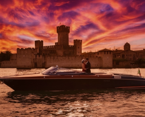 Romantic Riva boat tour at sunset on Lake Garda with the castle of Sirmione in the background