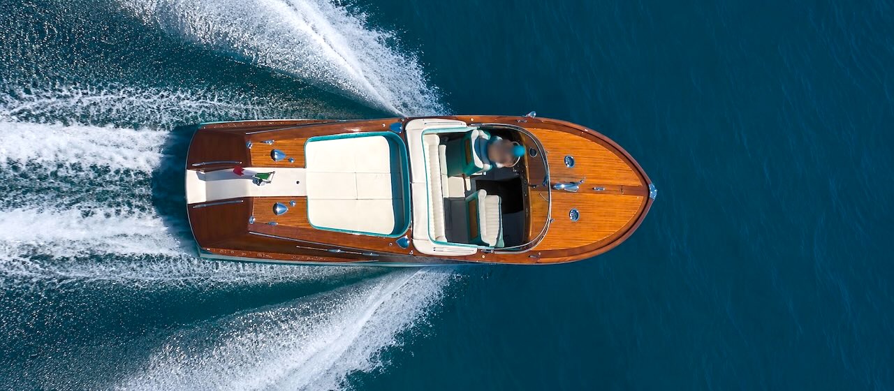Riva Aquarama Rental – Private Luxury Boat Experience in Italy Aerial view of a Riva Aquarama during a private boat tour in Italy, an exclusive luxury charter experience on the water.