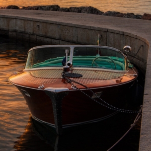 Classic Riva Ariston vintage wooden boat at sunset ready for a private charter experience