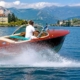 Classic Riva speedboat cruising on Lake Maggiore during an exclusive private charter experience